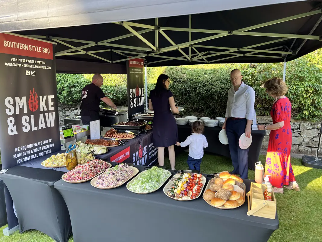 Guests helping themselves at the buffet under the gazebo
