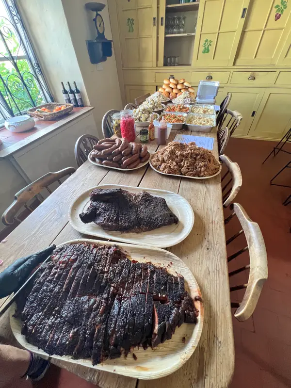Brisket and sides laid out on a long wedding table