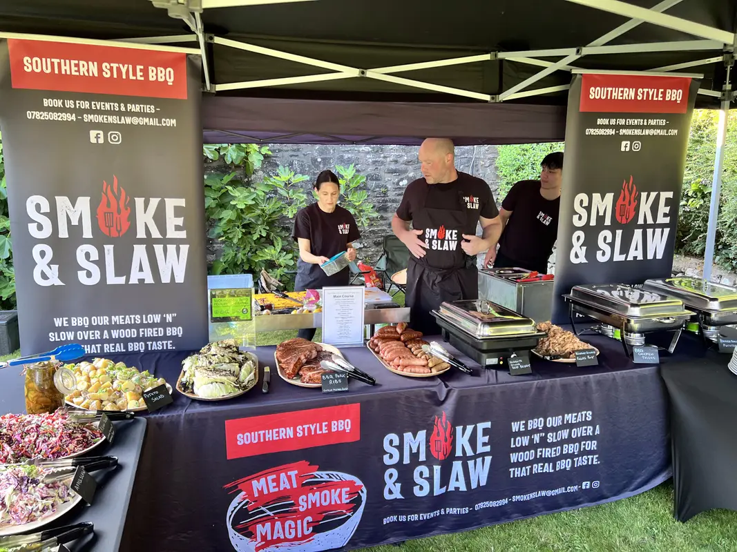 The team serving from the buffet at a garden event