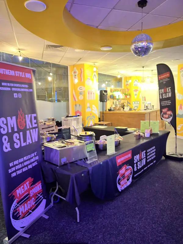 Smoke & Slaw stand set up inside an event venue