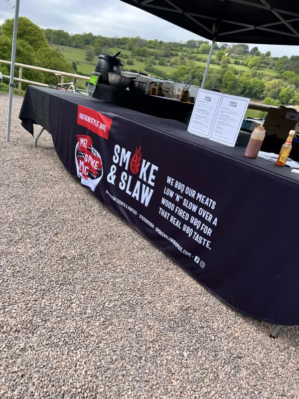 Smoke & Slaw serving table set up with a view over the hills
