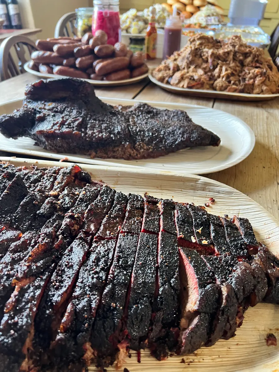 Smoked brisket, sausages and pulled pork laid out at a wedding